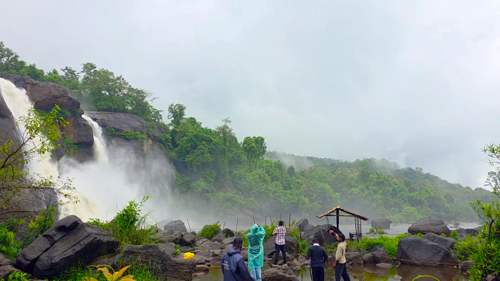 Athirapally Falls in Kerala with increased monsoon water flow surrounded by lush green forests