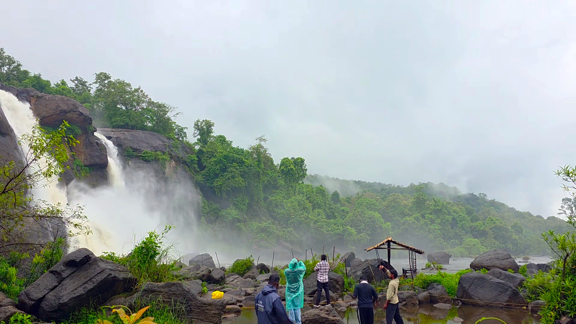 Athirapally Falls in Kerala with increased monsoon water flow surrounded by lush green forests
